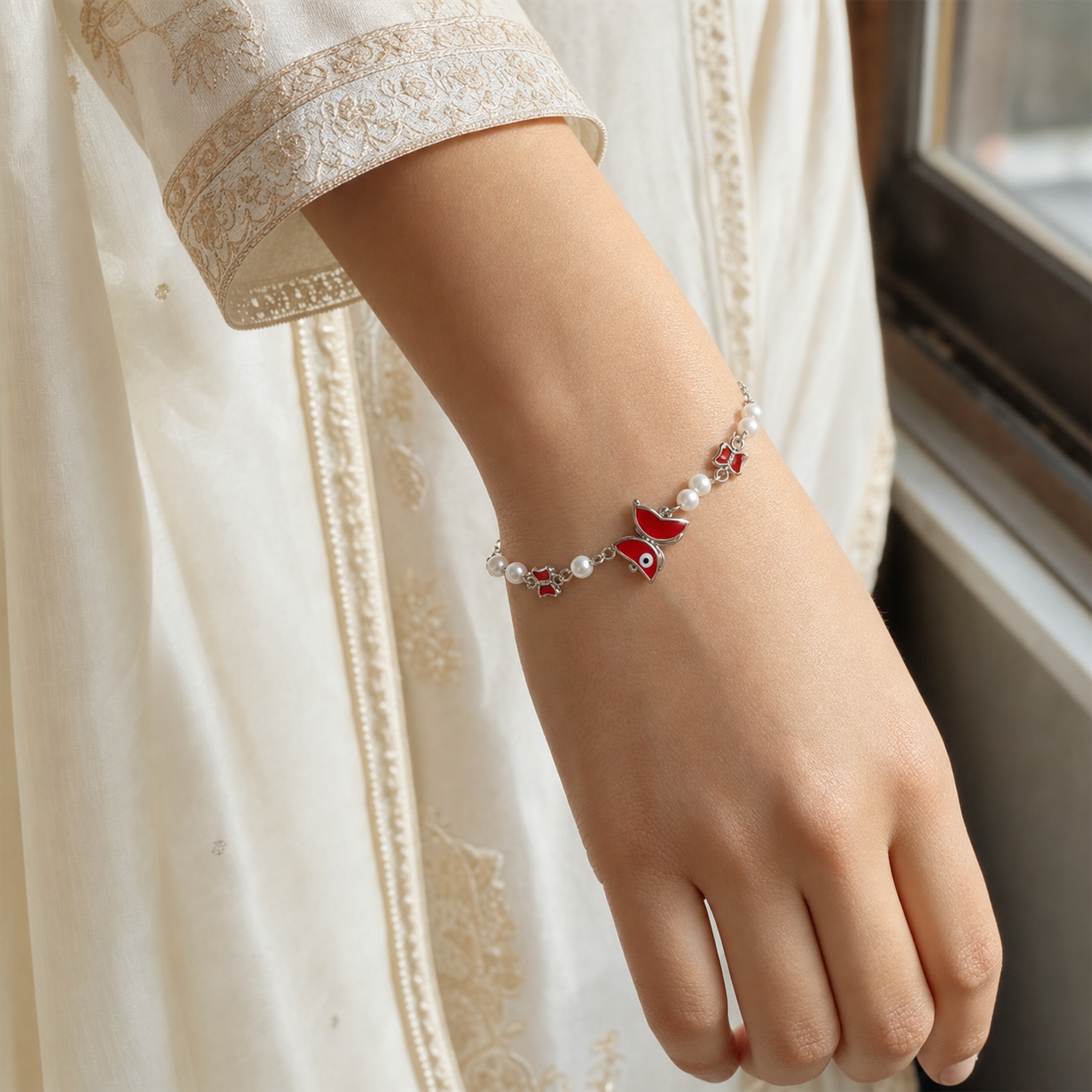 Silver Evil Eye Rakhi Bracelet with Pearls & Butterfly Charm – Nazar Protection Bracelet | Labh Ethnica