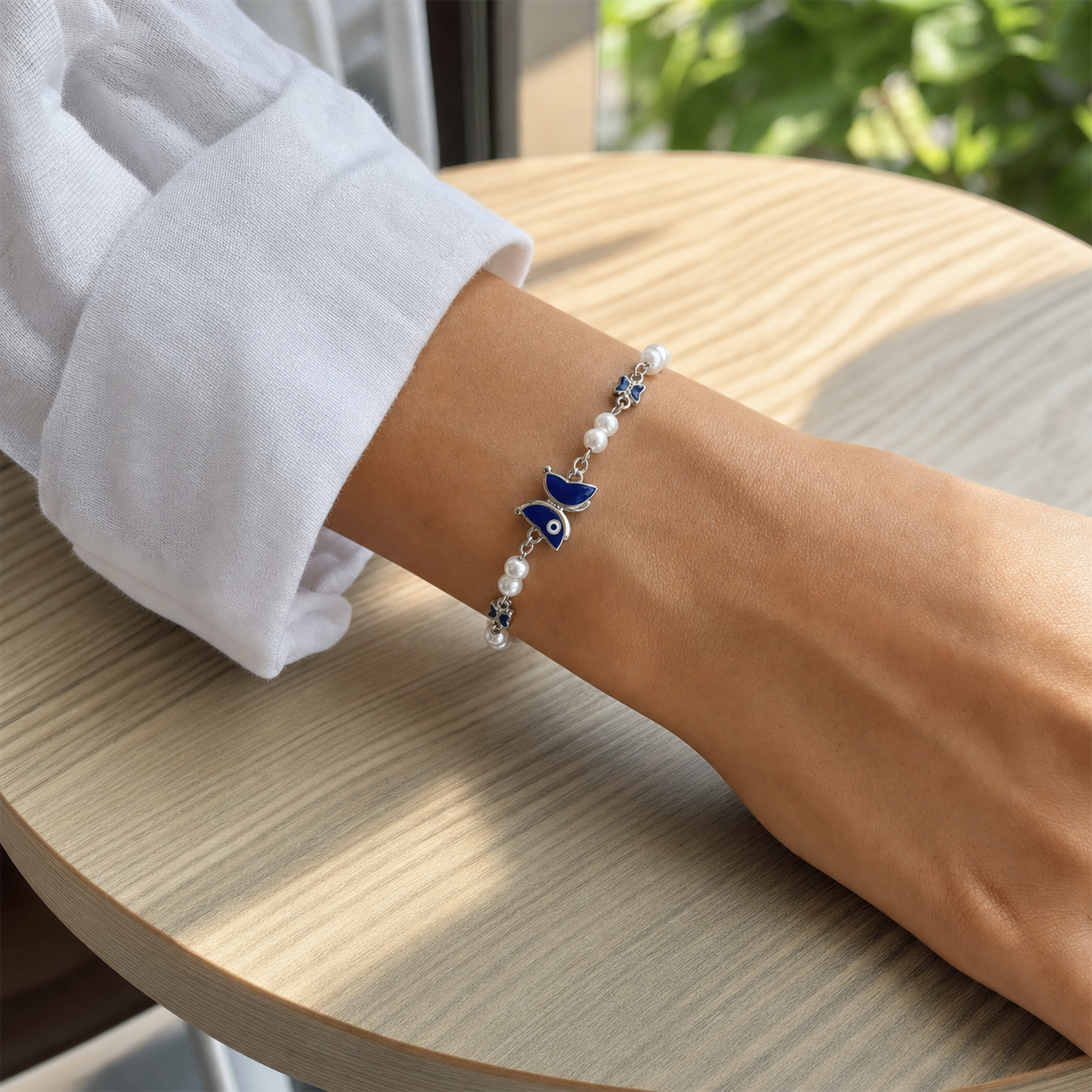 Silver Evil Eye Rakhi Bracelet with Pearls & Butterfly Charm – Nazar Protection Bracelet | Labh Ethnica