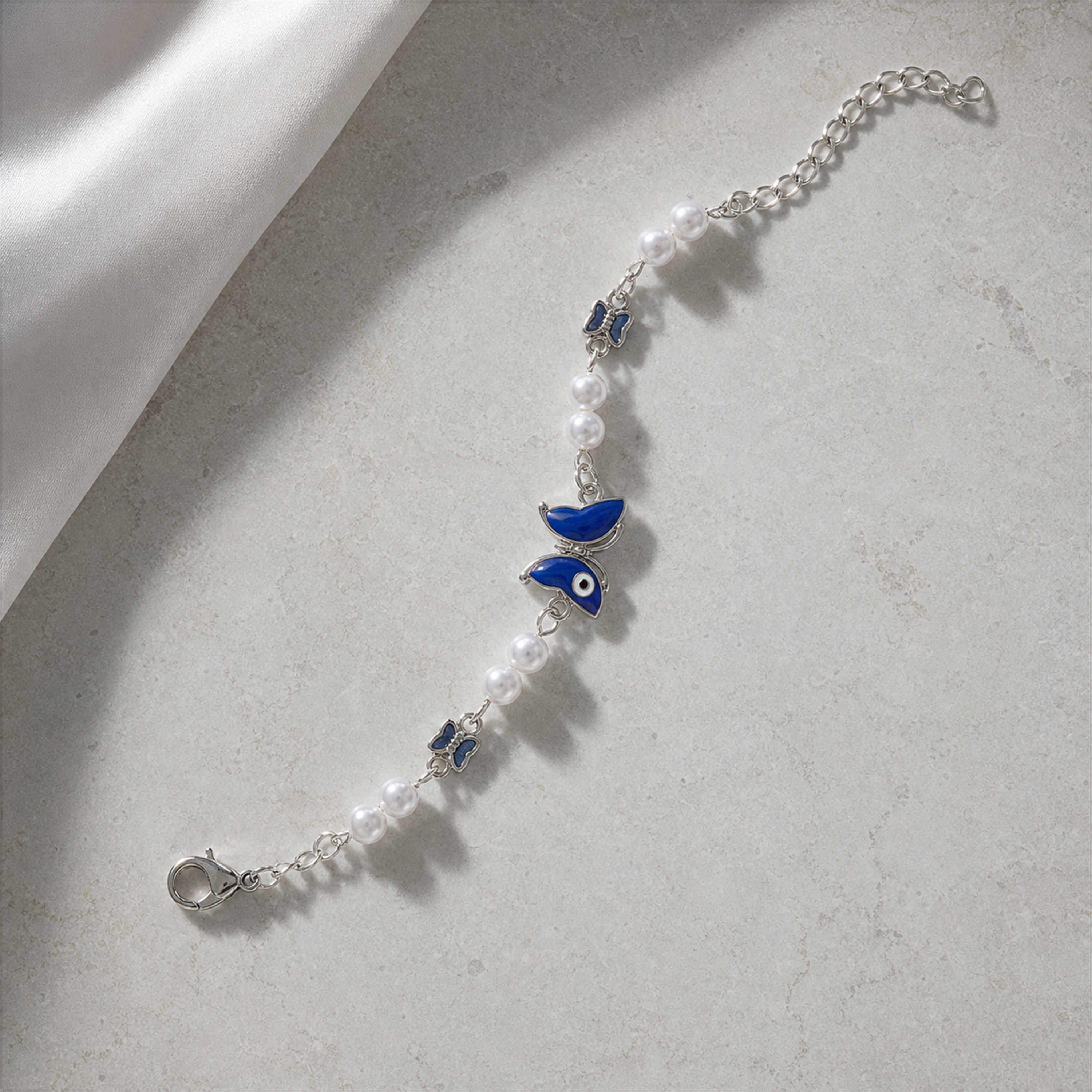 Silver Evil Eye Rakhi Bracelet with Pearls & Butterfly Charm – Nazar Protection Bracelet | Labh Ethnica