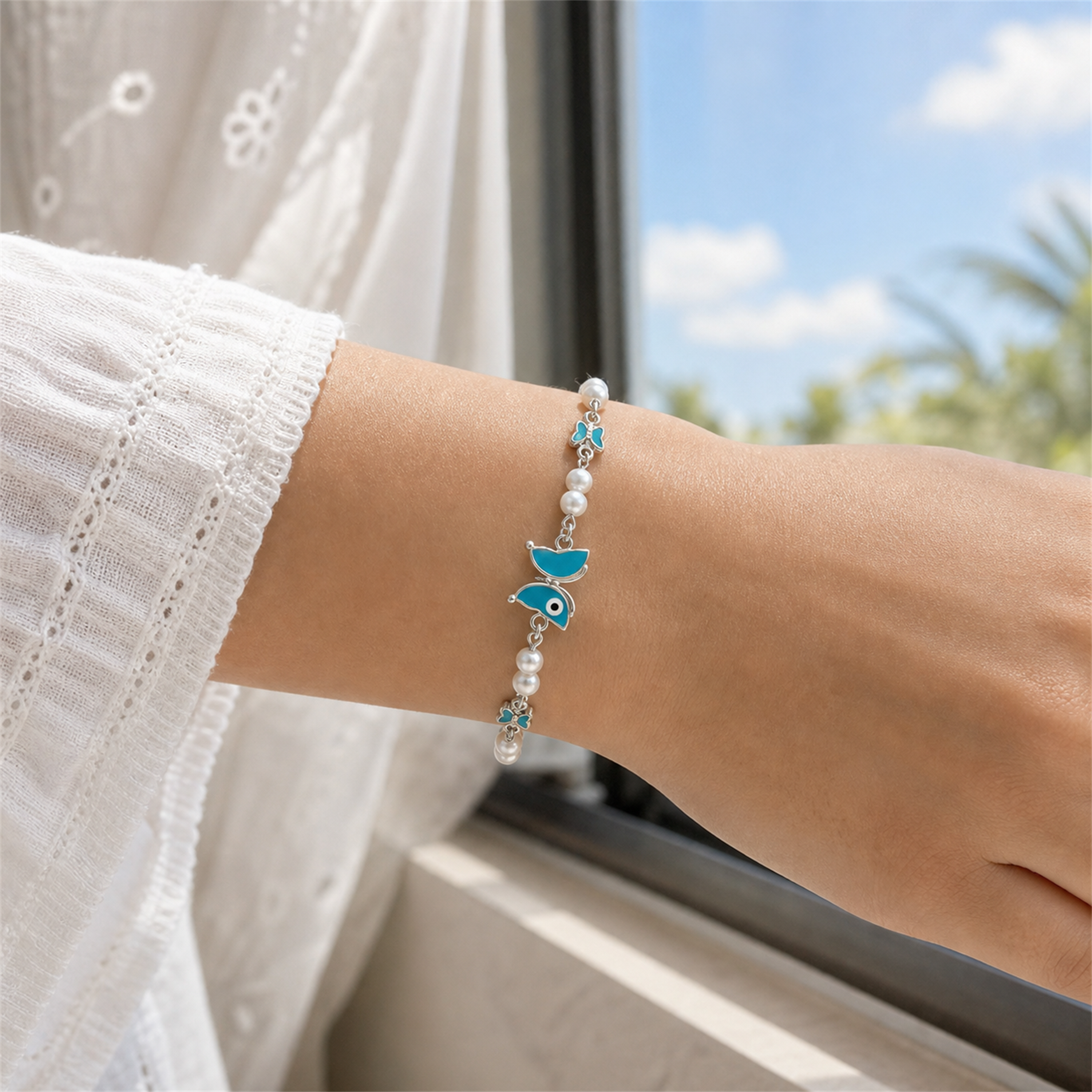 Silver Evil Eye Rakhi Bracelet with Pearls & Butterfly Charm – Nazar Protection Bracelet | Labh Ethnica