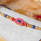 Pink Swastik Rakhi bracelet for brother with red and blue beads - swastik rakhi