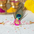 Peacock feather Krishna style Rakhi bracelet with pink and white beads - krishna rakhi